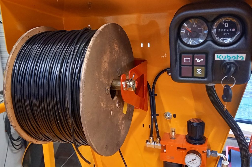 Holder for tying tube on spool on cowl panel